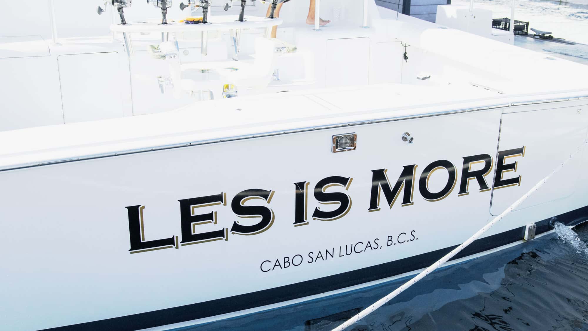 White transom lettered Les Is More, Cabo San Lucas, B.C.S., with the cockpit above
