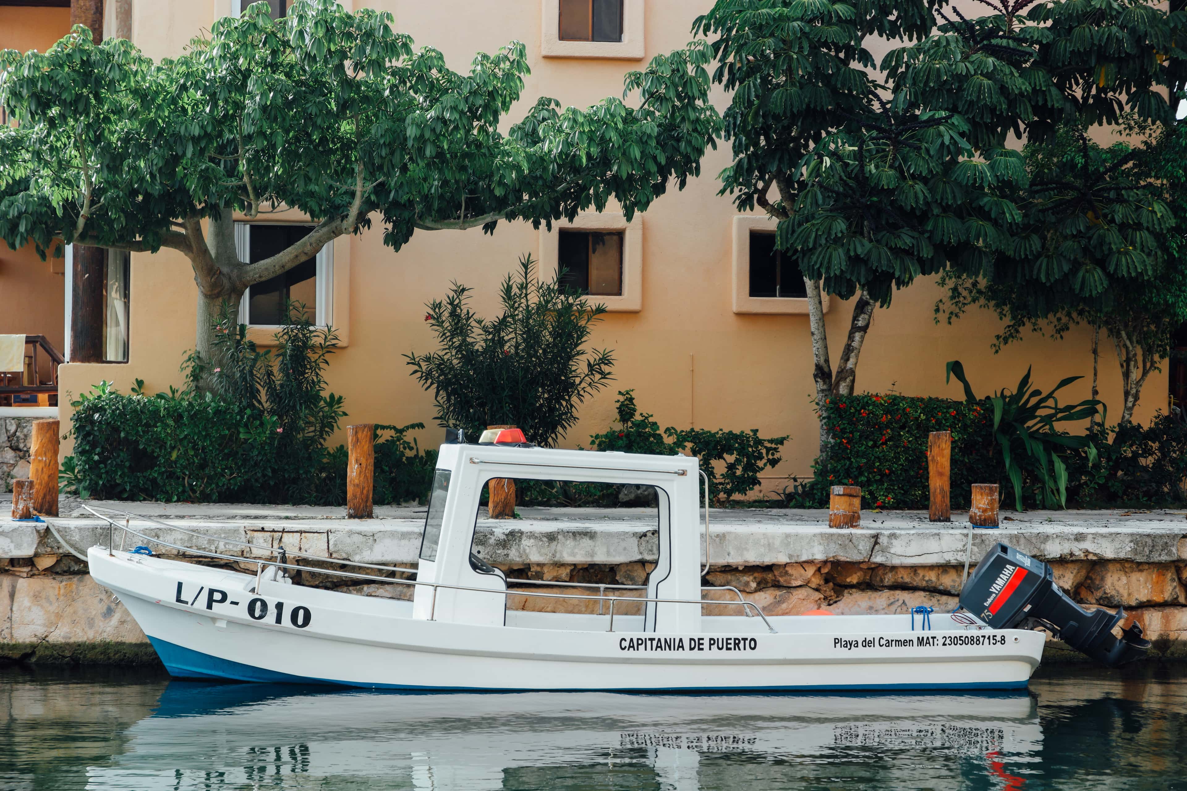 Puerto Aventuras: a boat moored in a marina canal