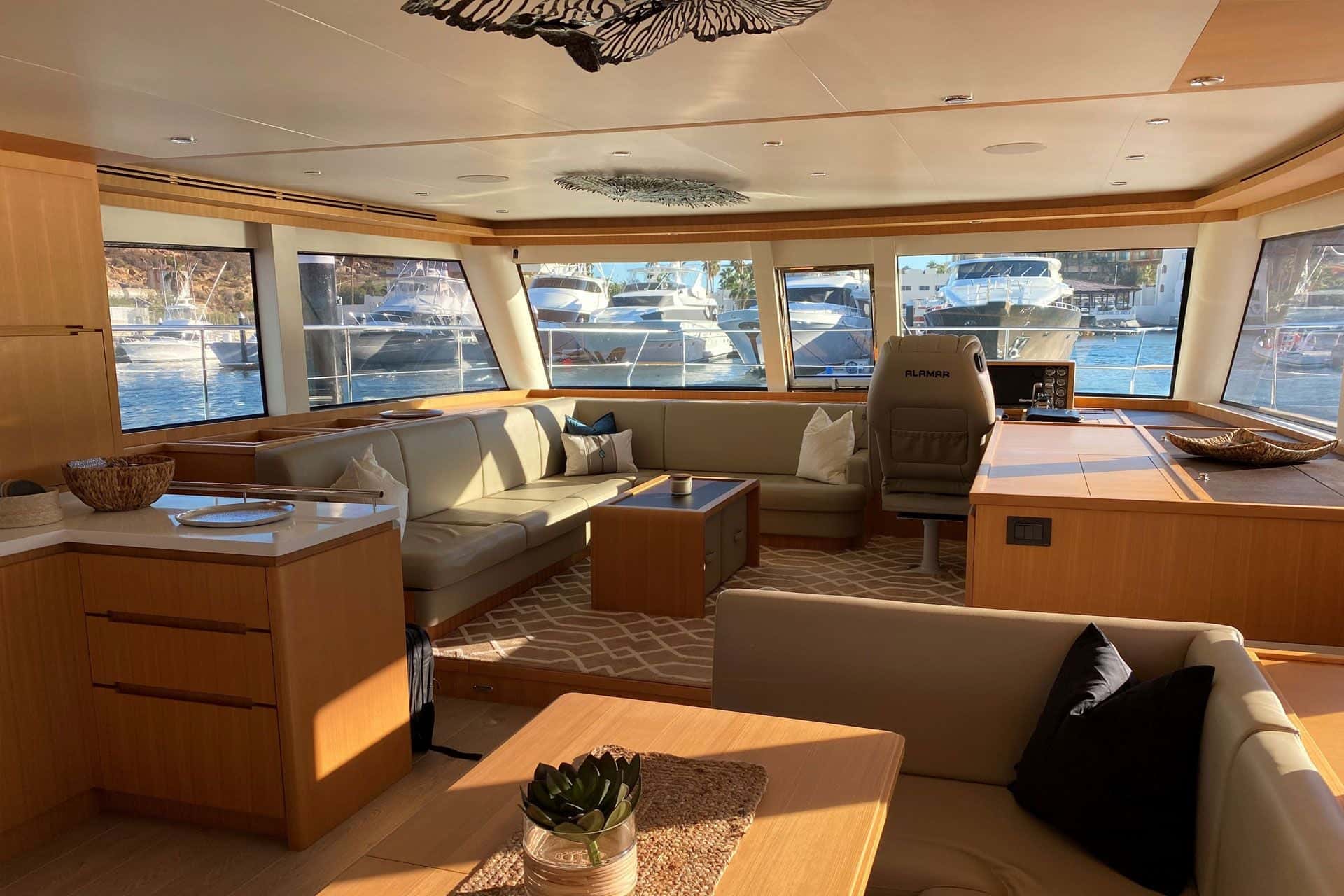 Saloon corner sofa and coffee table, the helm seat and wraparound windows forward