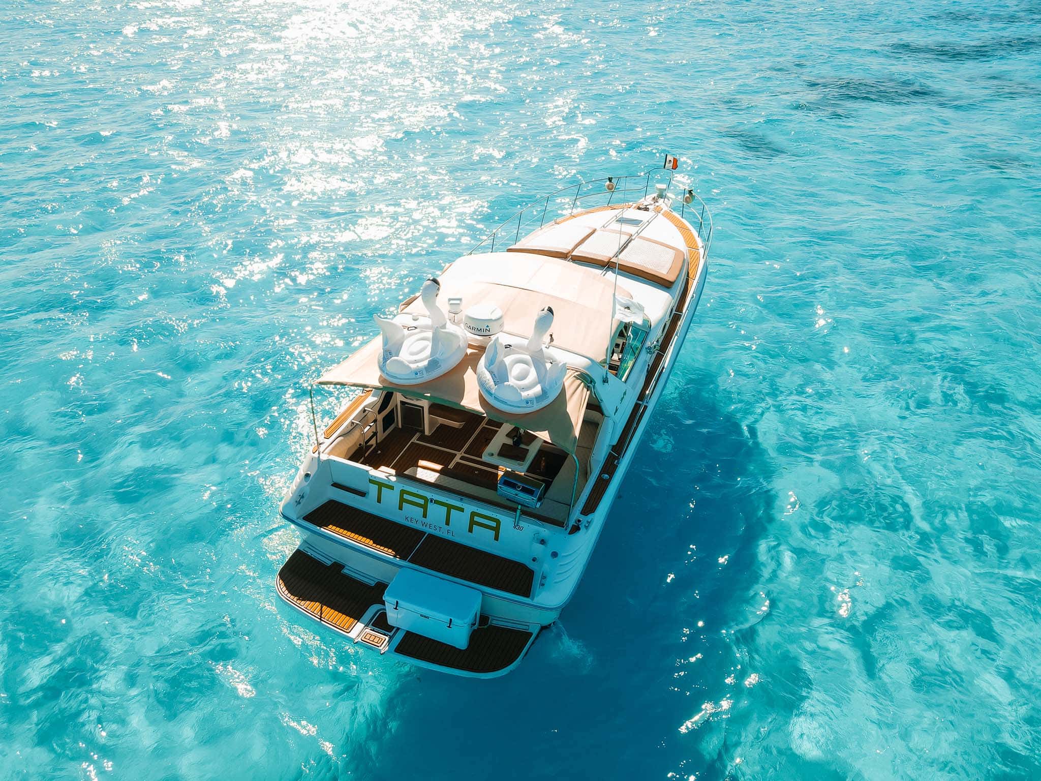 Tata from astern, with the cockpit lounge under the shade cover and the swim platform