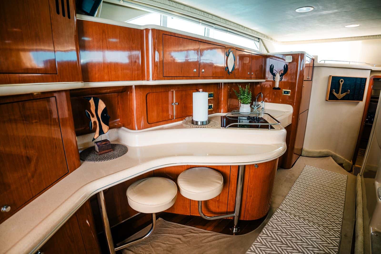 Galley counter with two stools and cherry joinery on Mr Sea