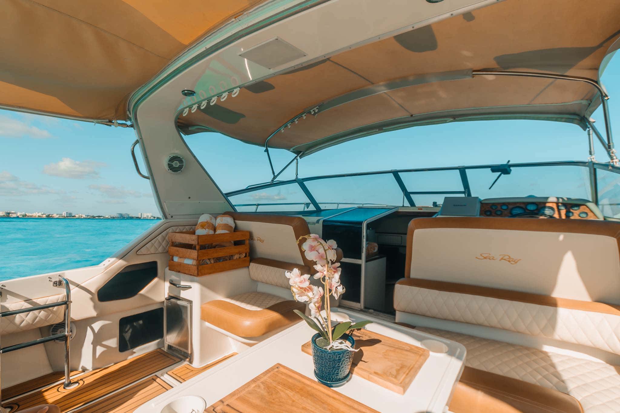 Tata cockpit with the helm to starboard, lounge and table, and a wide windshield