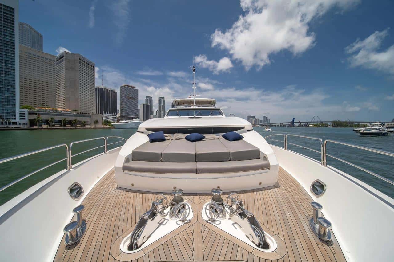 Foredeck with a large cushioned sun pad, teak deck and anchor gear in the foreground