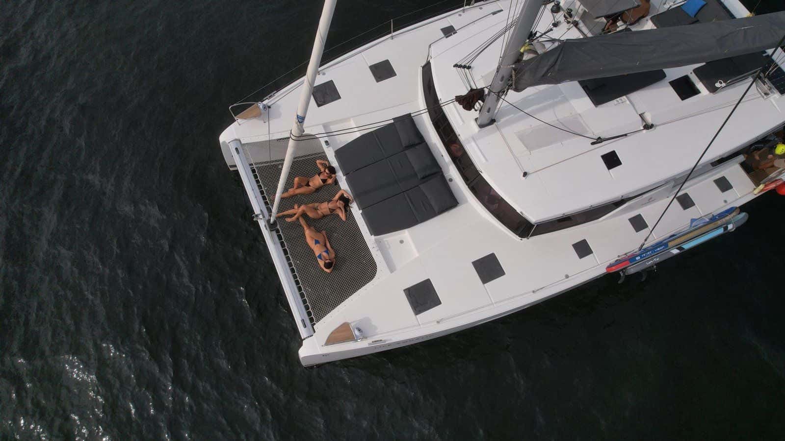 Aerial view of the bow net and sunpads, with three people lying on the net