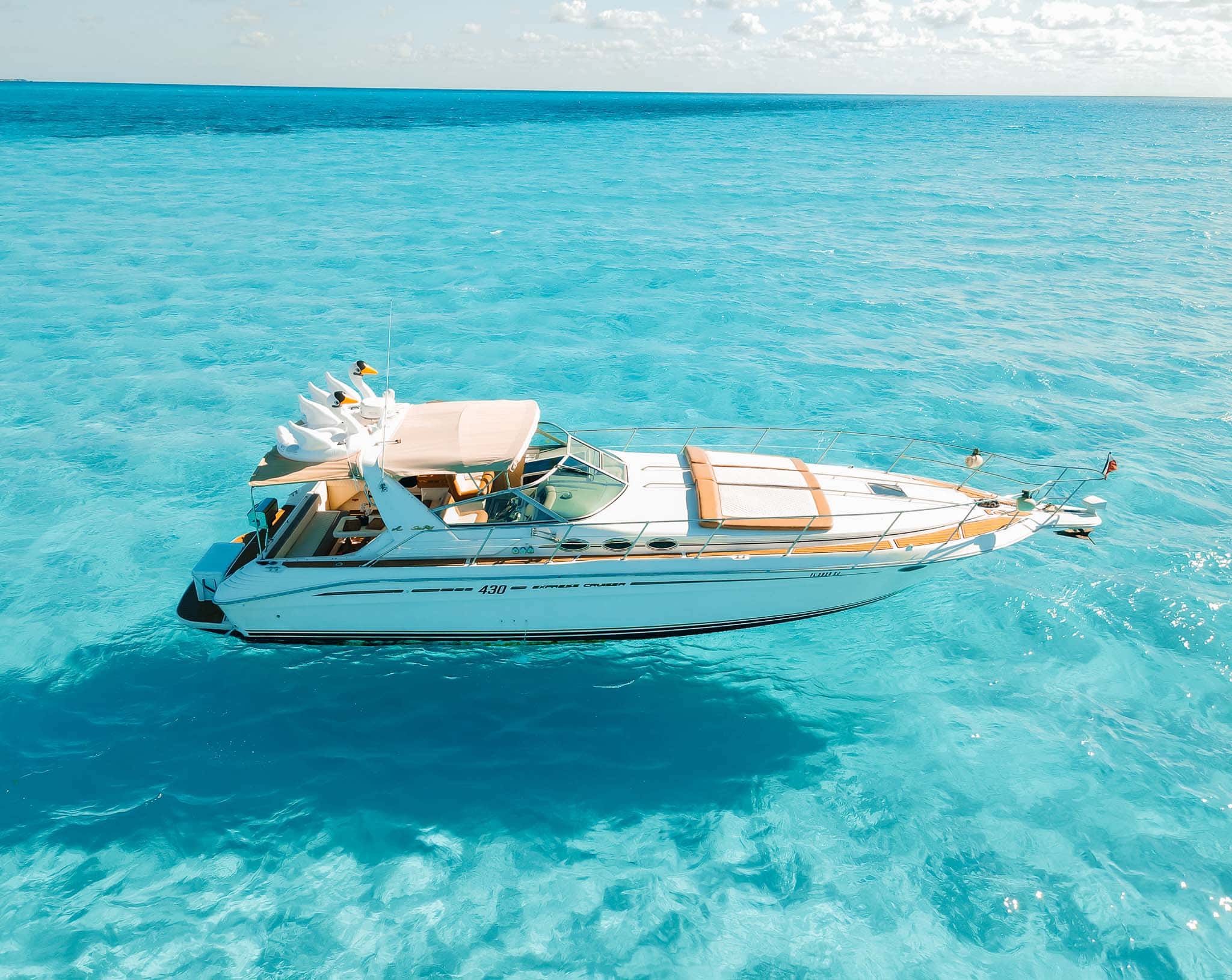 Tata seen from the air in full side profile on turquoise shallows, swan floats on the cockpit roof