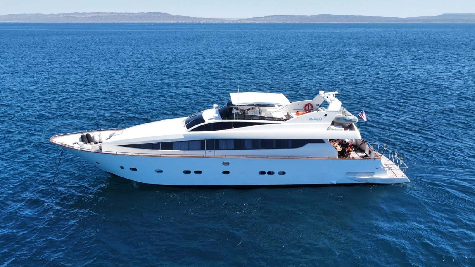 Avante in profile on open blue water, the flybridge and long white hull in full view