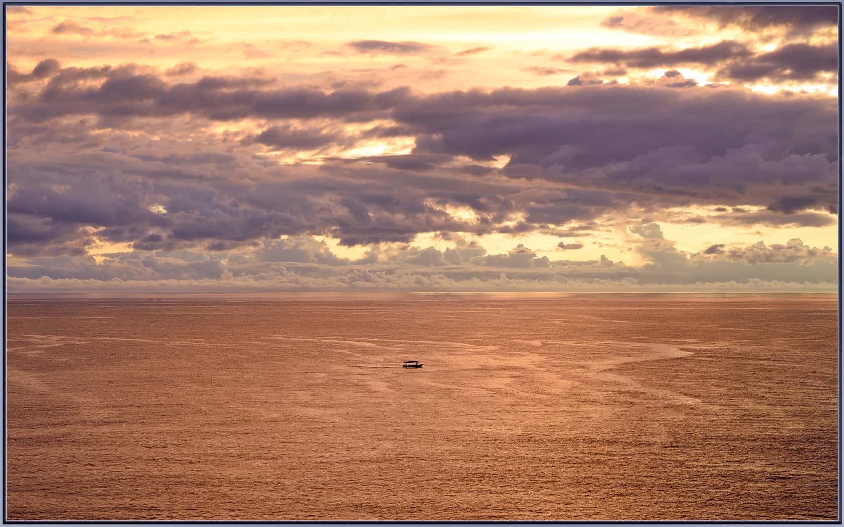 Puerto Vallarta: a fishing boat heading back to port at sunset