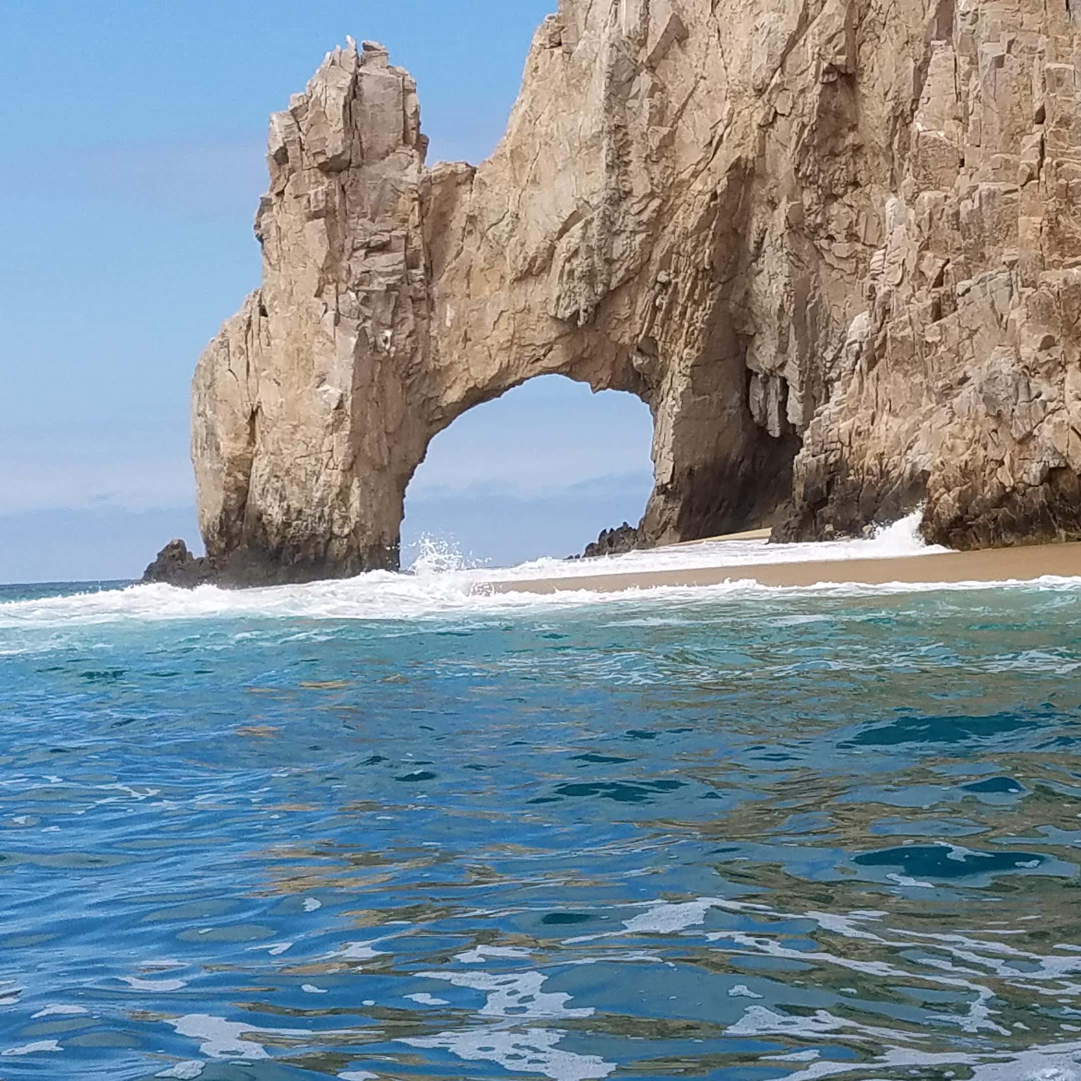 El Arco, Cabo San Lucas: the arch from water level, surf and sand beneath it