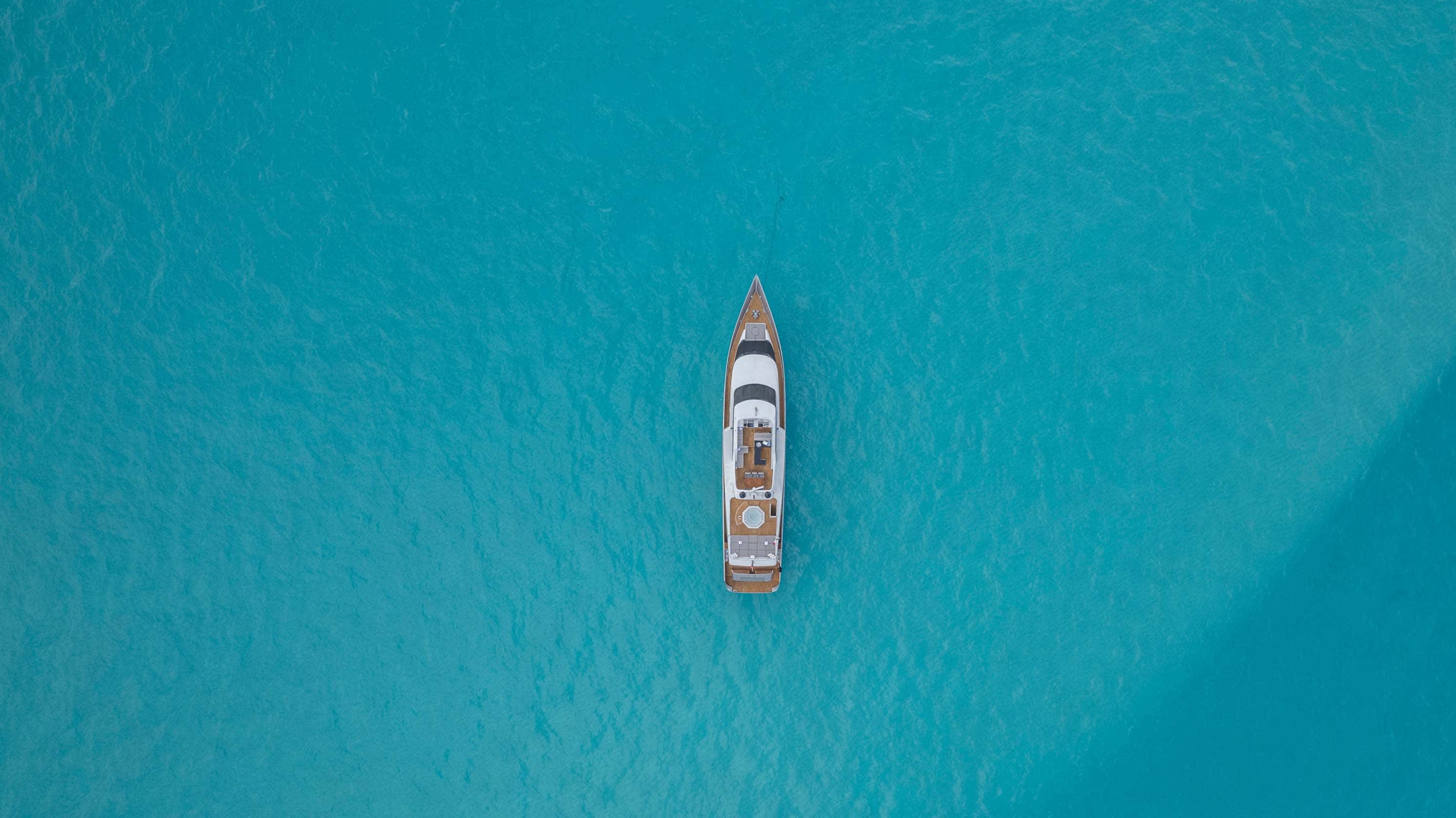 Aerial view straight down on the Avalon at anchor over pale sand banks