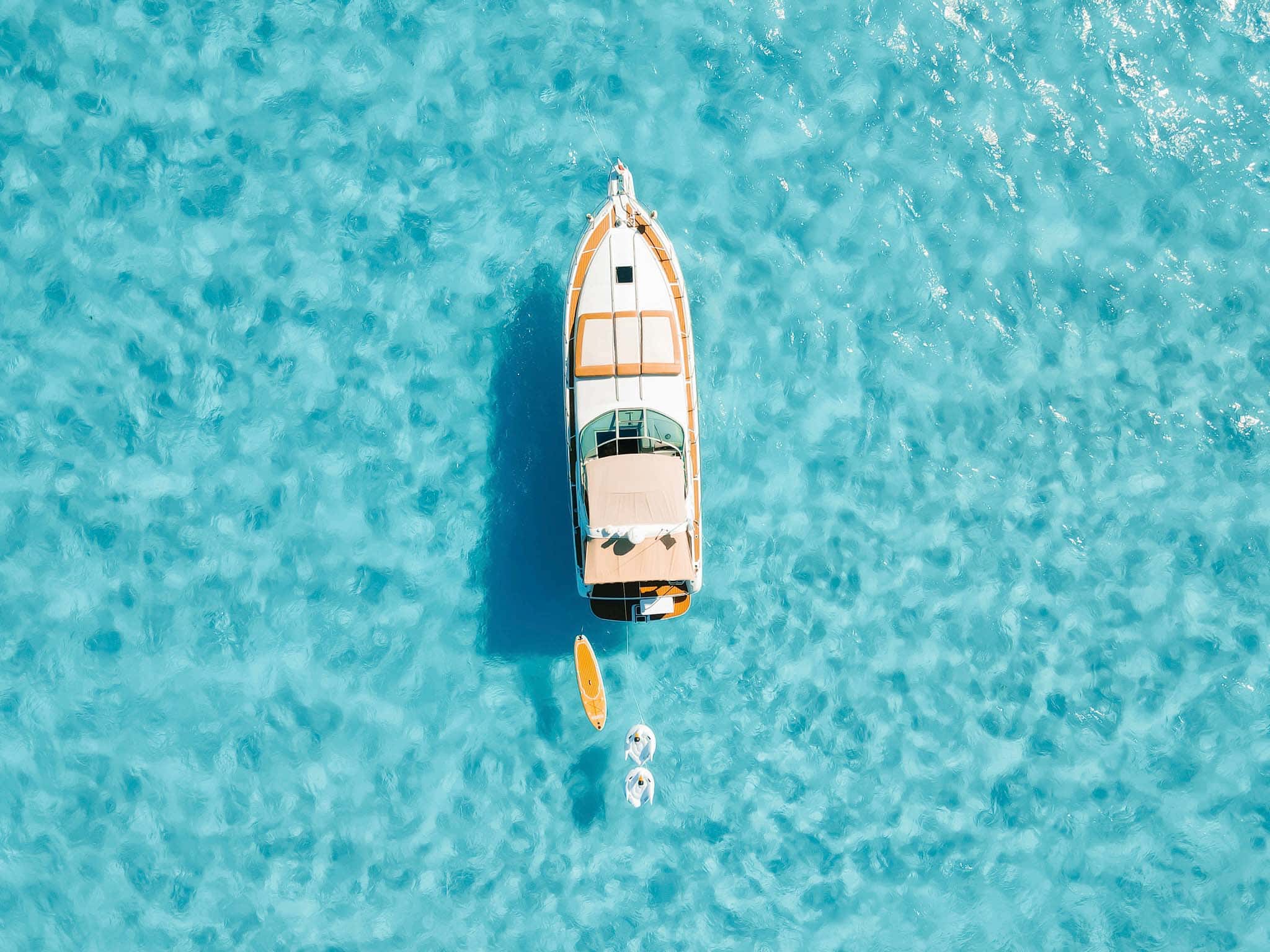 Straight down aerial of Tata with a paddle board and floats astern