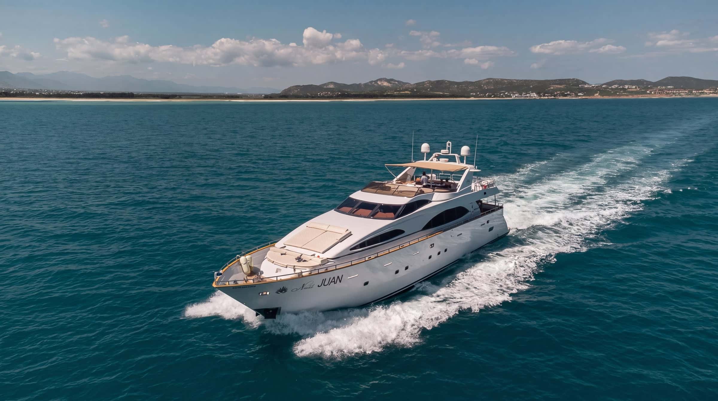 Number Juan, a white 100-foot motor yacht, cruising on turquoise water with a white wake