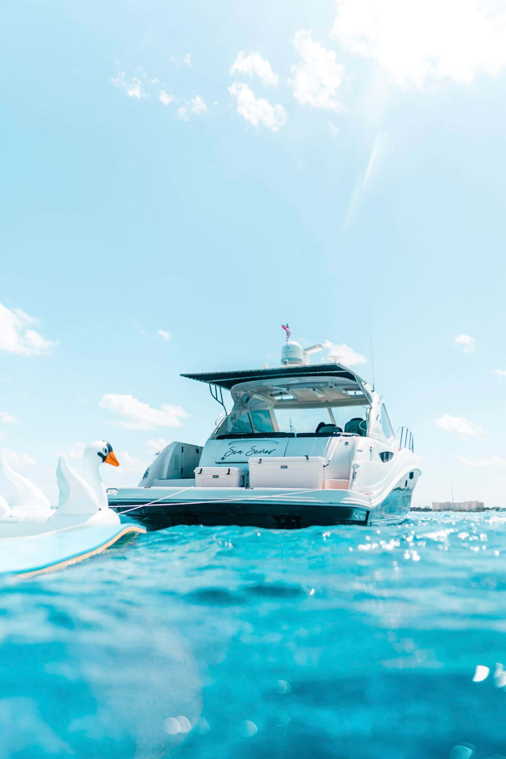 Stern of Sea Señor from the water with the swim platform and a swan float