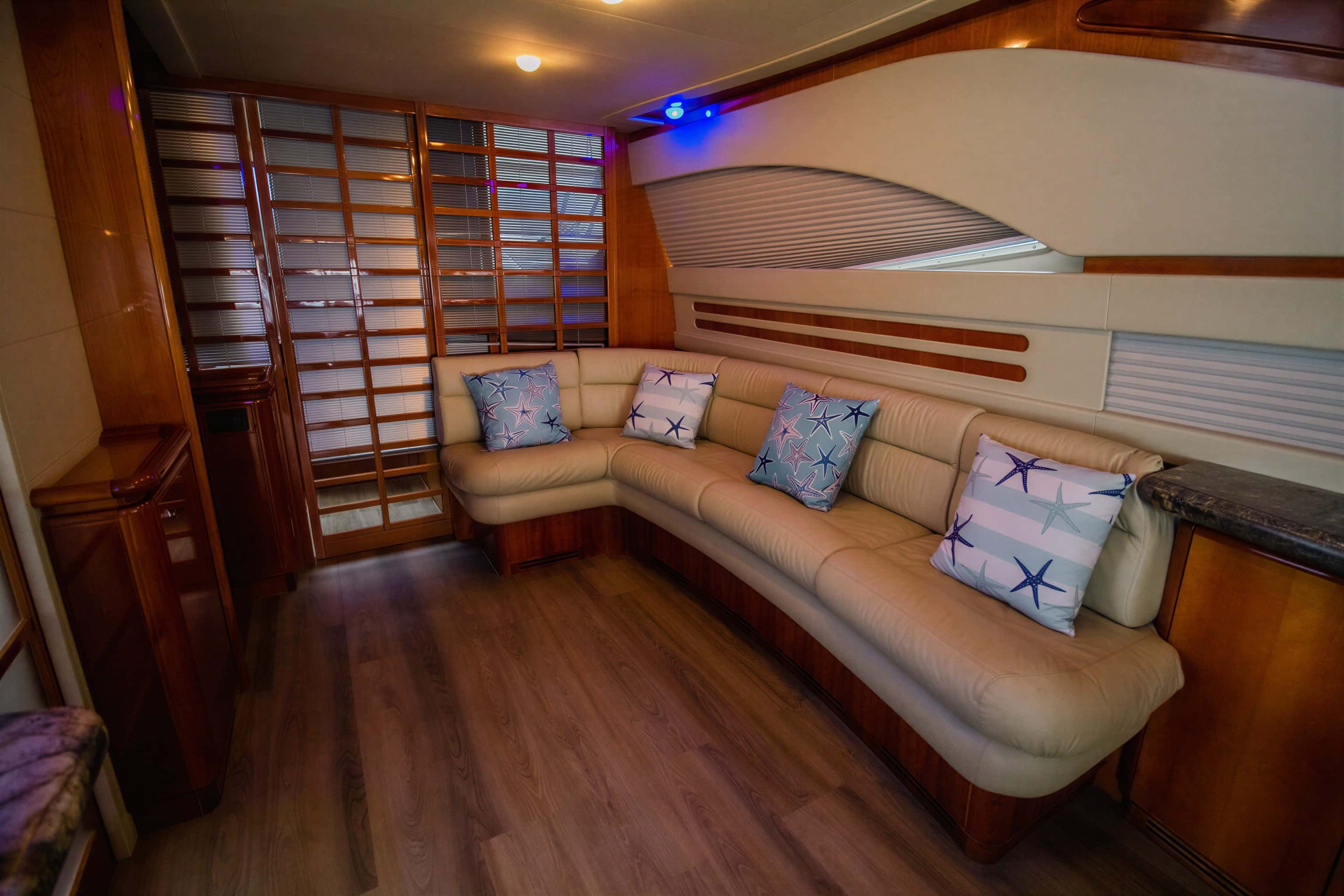 Saloon corner sofa with starfish cushions, wood panelling and a lattice door