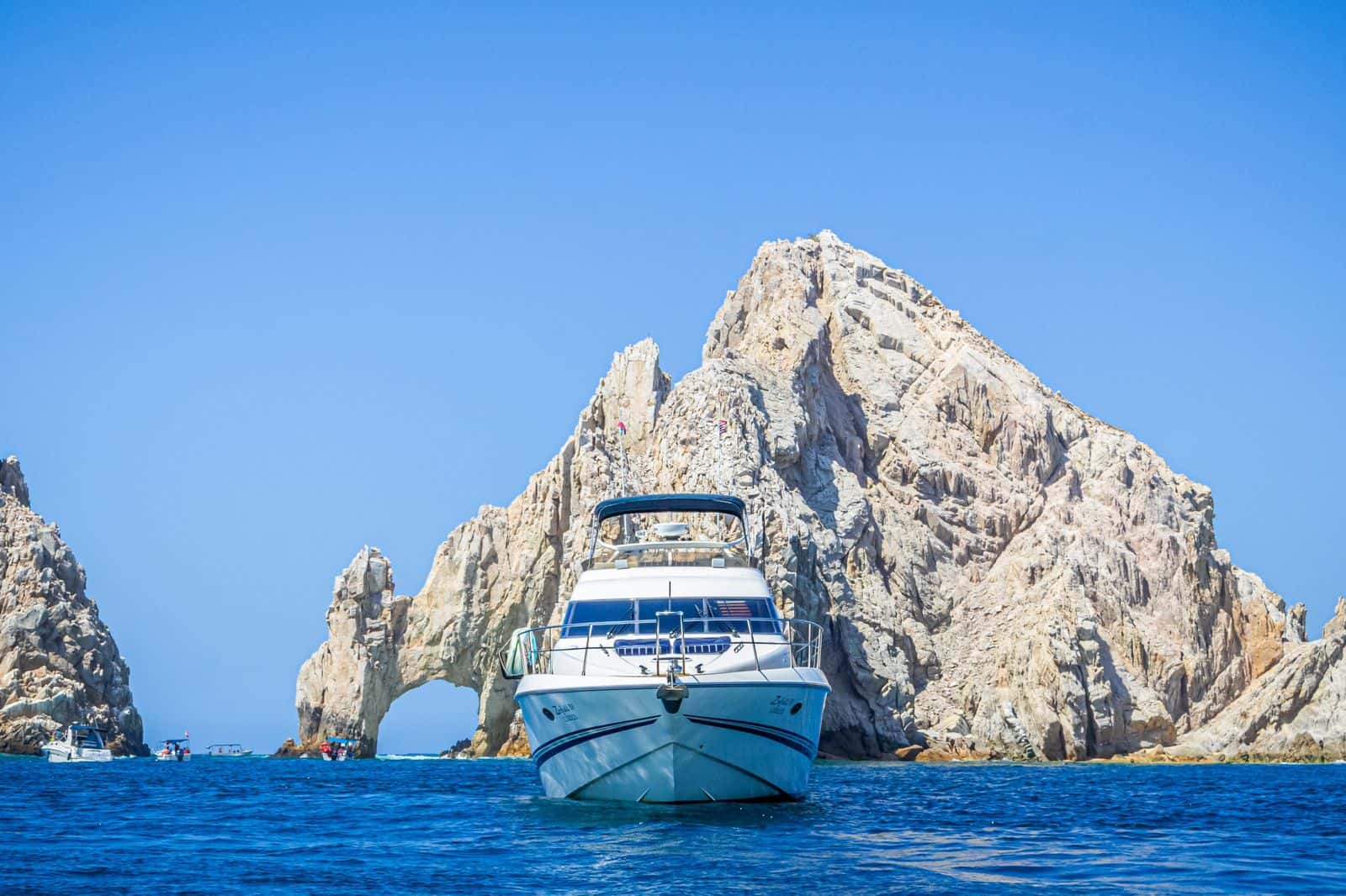 Zinfull seen head-on from the water with the rocky Cabo arch behind it