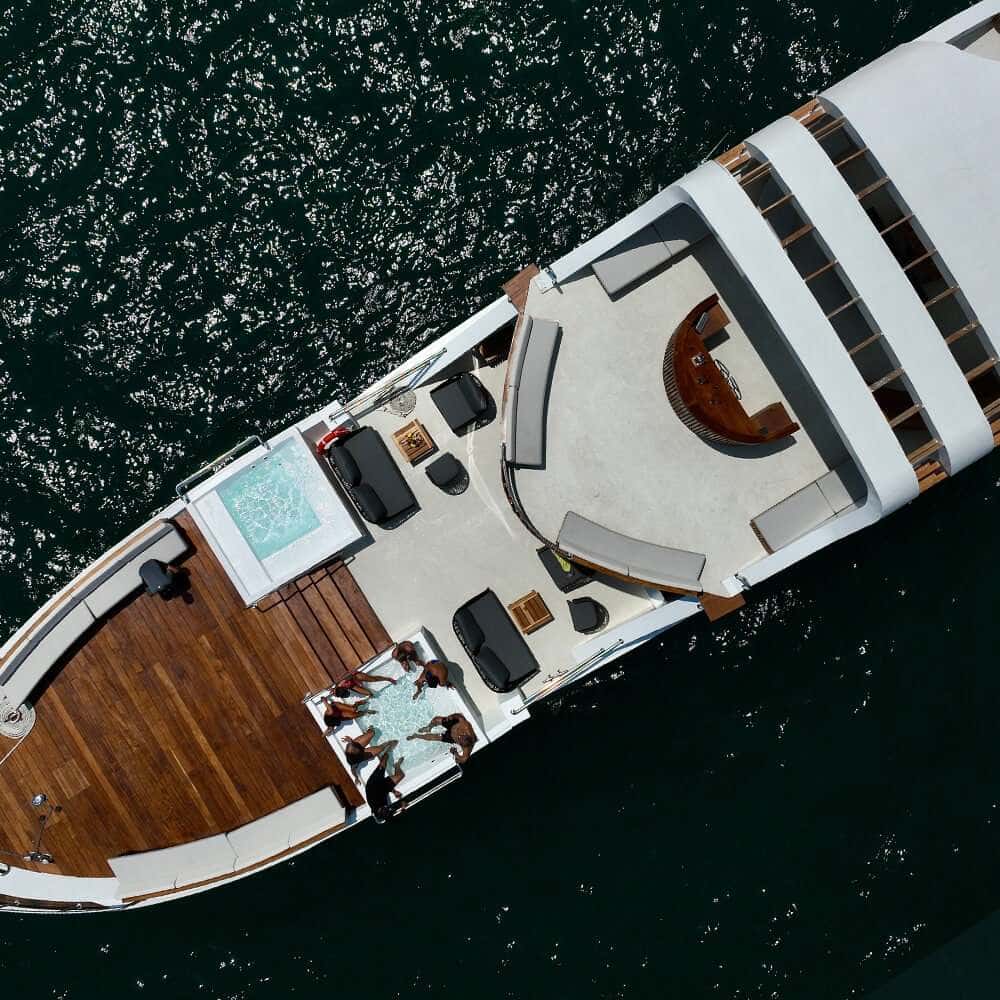 Aerial view of the foredeck with teak bow seating, two plunge pools and lounge furniture