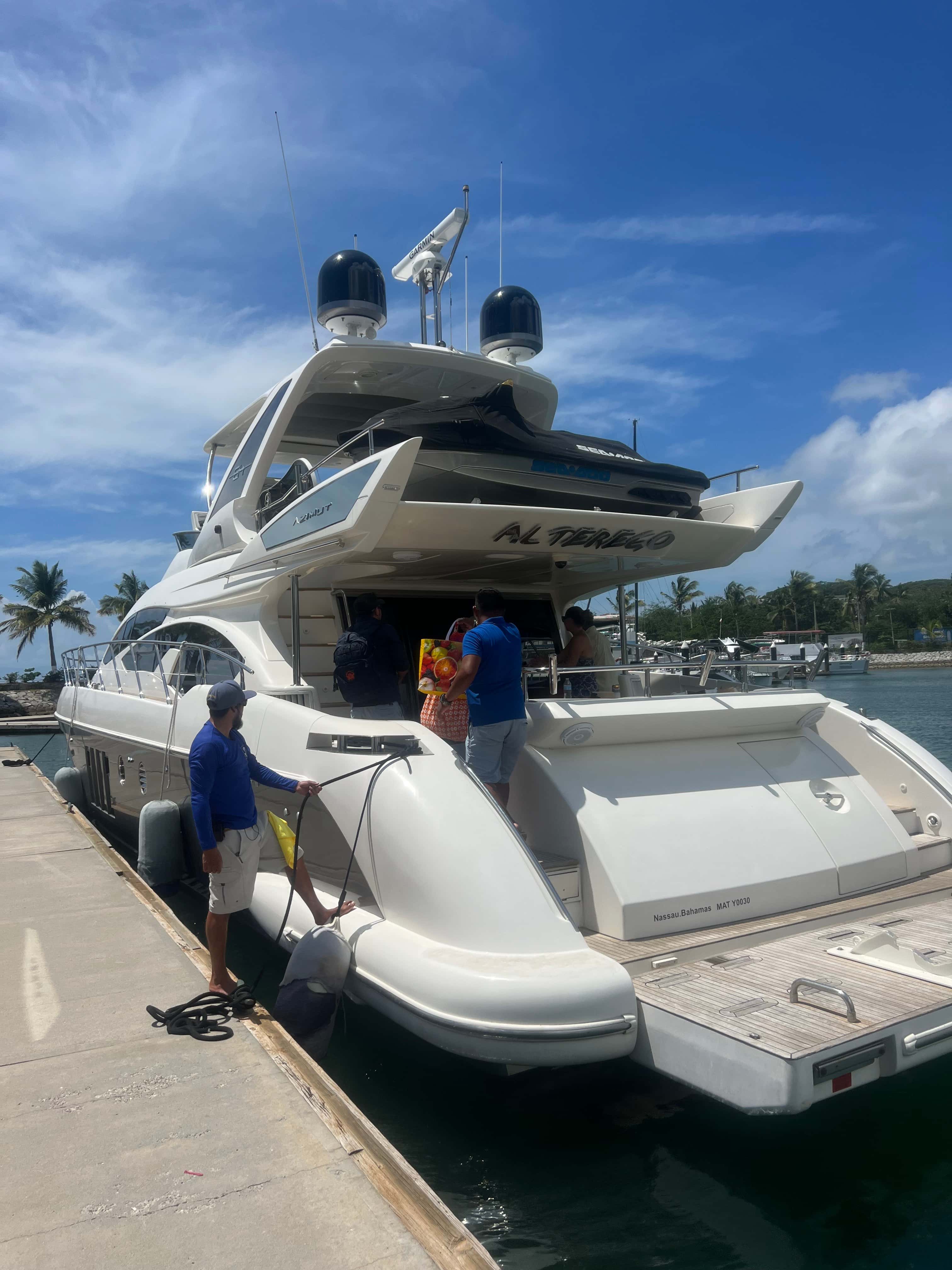 Alterego, seen from astern at the dock, jet ski on the flybridge and crew loading provisions