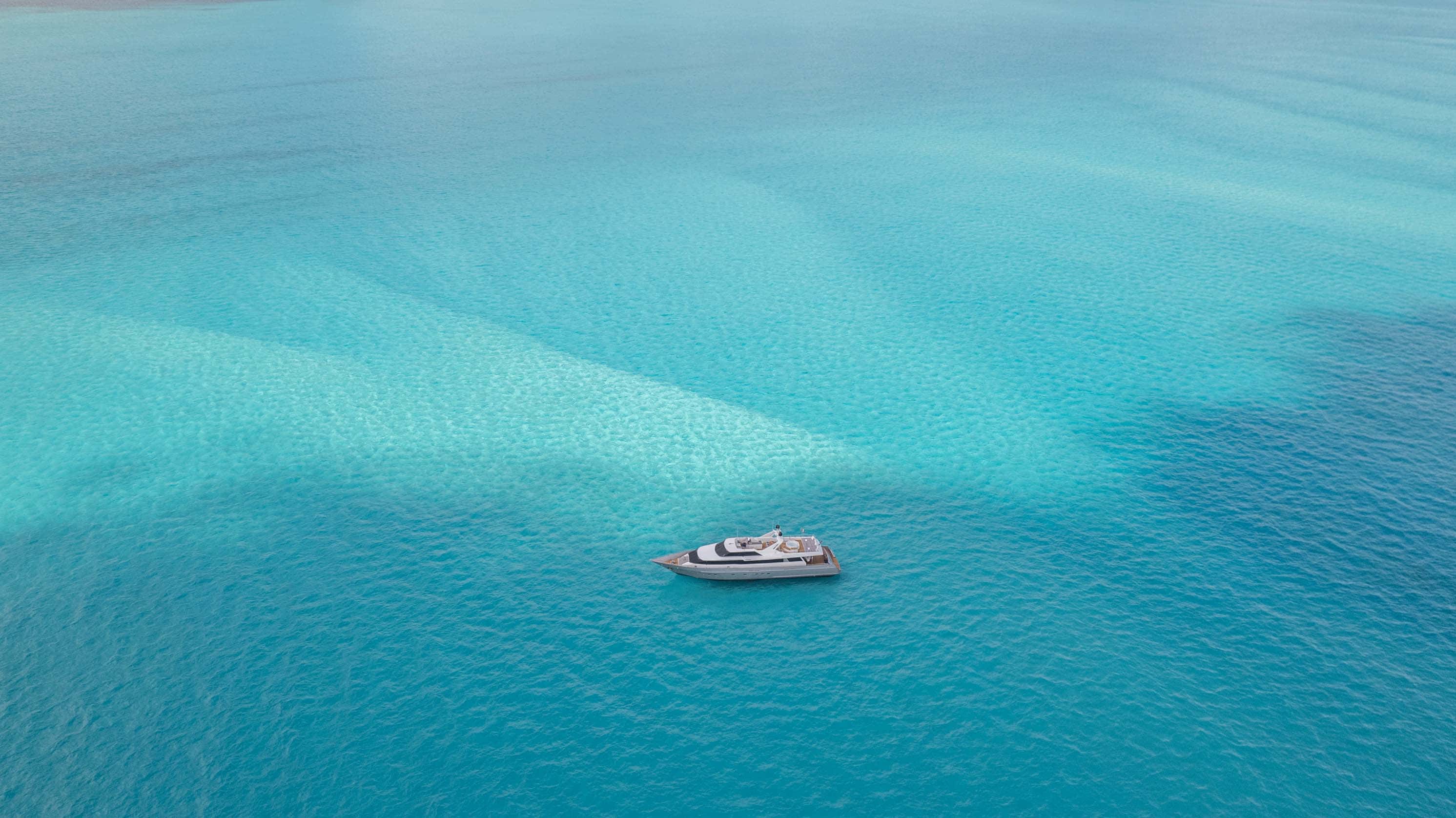 Aerial view of the whole Avalon at anchor over sand banks and turquoise water