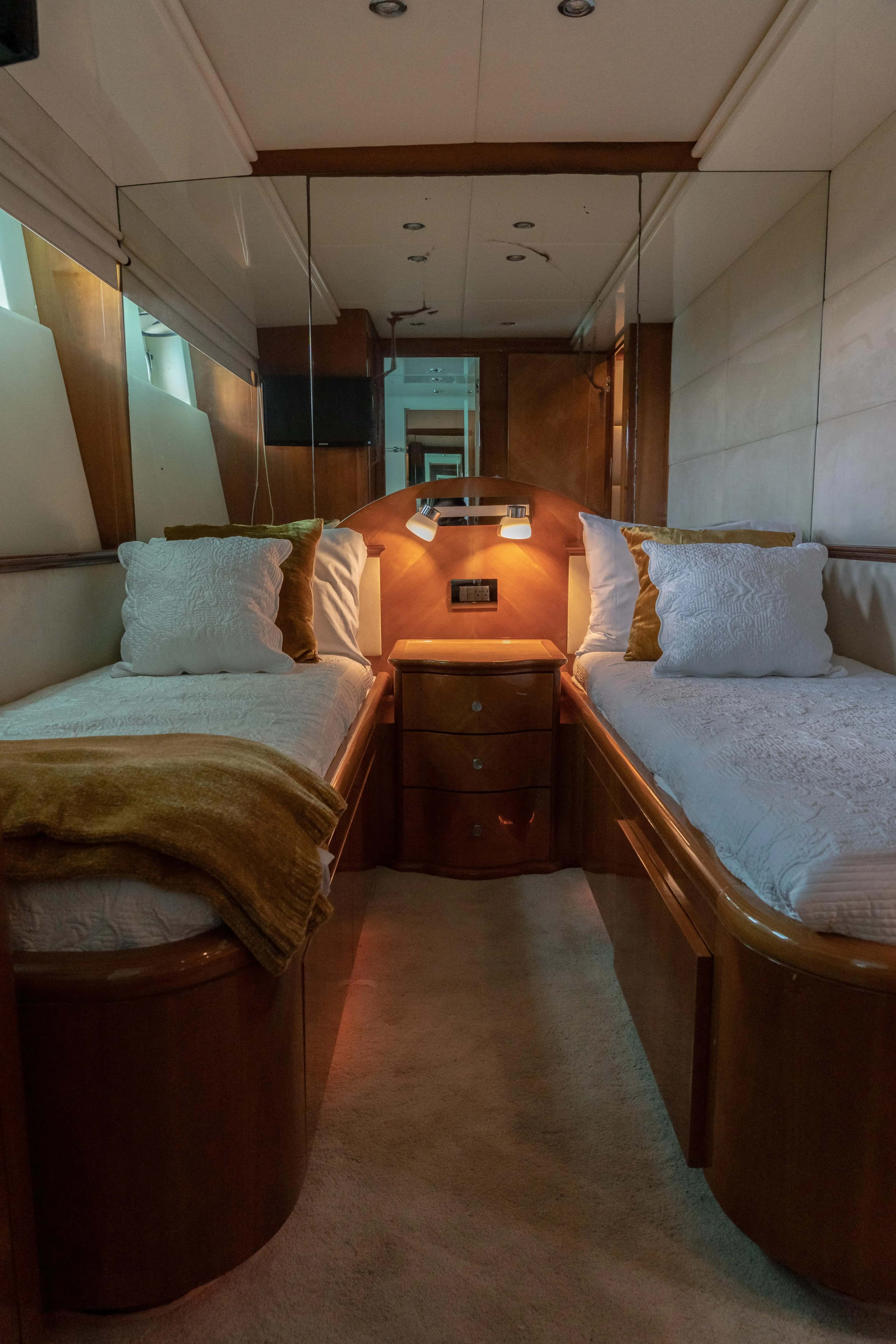 A twin cabin with two single beds and a nightstand between them