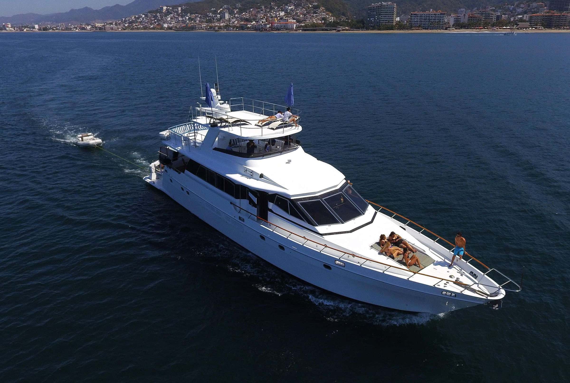 Aerial view of Princess Elyse cruising Banderas Bay with guests on the foredeck and a wave runner in her wake