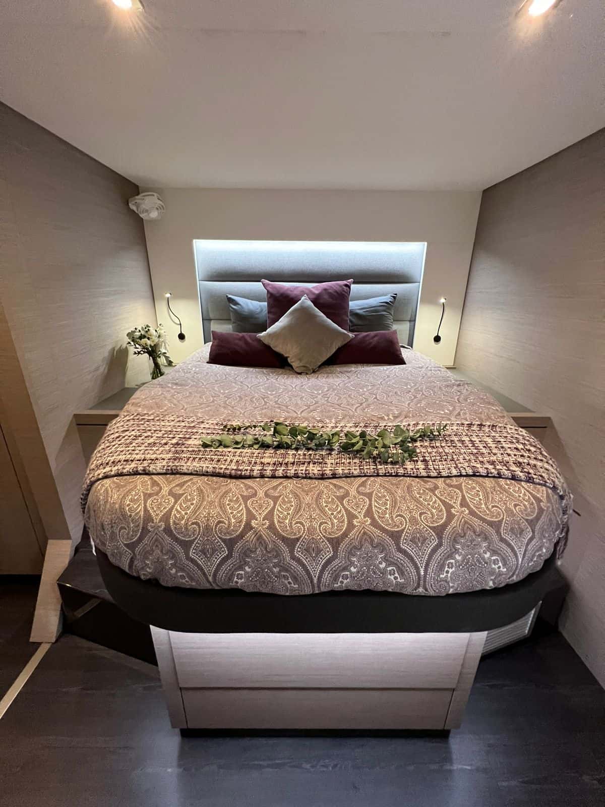 Double cabin with a padded headboard, paisley bedding and reading lights